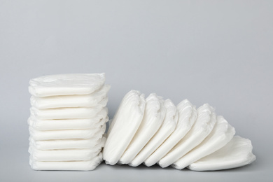 Pile of baby diapers on light grey background