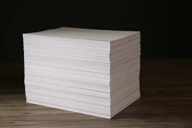Stack of paper sheets on wooden table