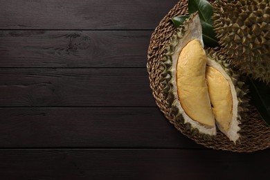 Fresh ripe durians on wooden table, top view. Space for text