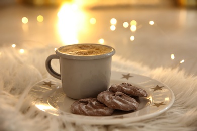 Tasty hot drink and cookies on fur