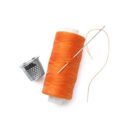 Spool of orange sewing thread with needle and thimble on white background, top view