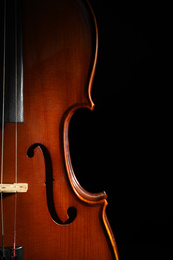 Classic violin on black background, closeup view