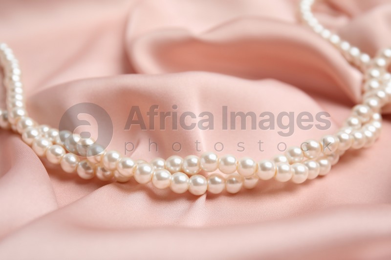Beautiful white pearls on delicate pink silk