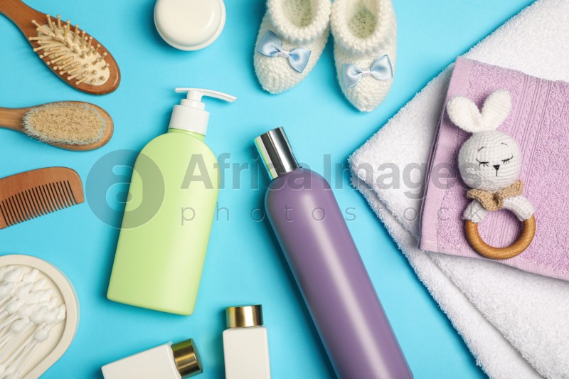Photo of Flat lay composition with baby cosmetic products on light blue background