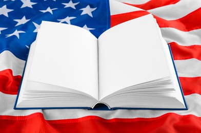 Open blank book on national American flag