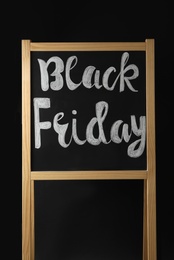 Board with phrase Black Friday on dark background