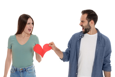 Couple tearing paper heart on white background. Relationship problems