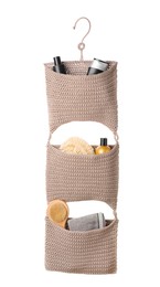 Stylish knitted organizer with toiletries and brush on white background. Bath accessory