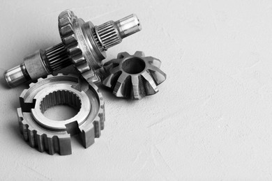 Photo of Different stainless steel gears on light grey background. Space for text