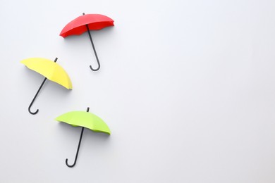 Different umbrellas on white background, top view. Space for text