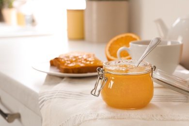 Breakfast with delicious orange marmalade on table. Space for text