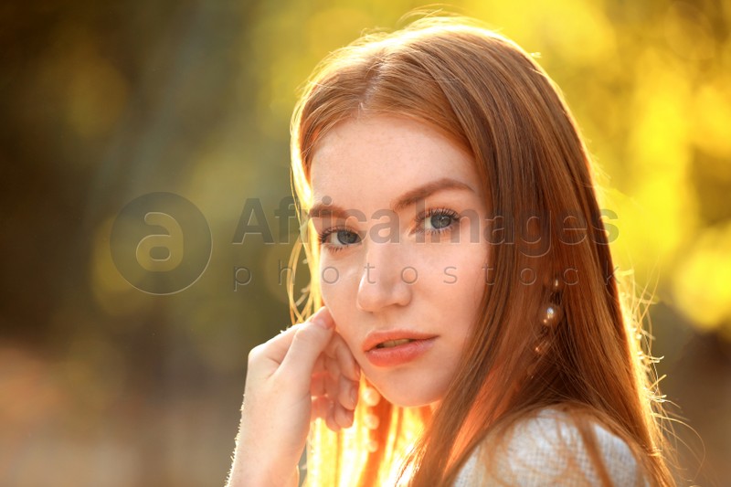 Beautiful young woman posing on blurred background