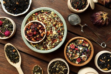 Photo of Many different herbal teas on wooden table, flat lay