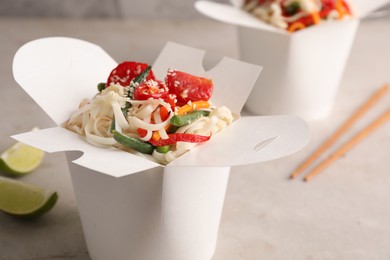 Box of vegetarian wok noodles on light table, closeup