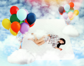 Sweet dreams. Bright cloudy sky with air balloons around sleeping young woman 