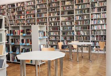 View of bookshelves and tables in library