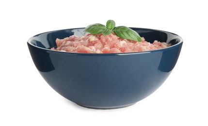 Raw chicken minced meat with basil in bowl on white background