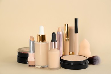 Foundation makeup products on beige background. Decorative cosmetics