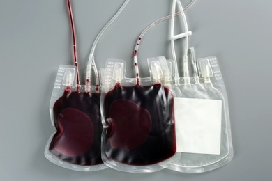 Photo of Blood packs on gray background, top view. Donation day