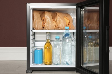 Mini bar filled with food and drinks indoors, closeup