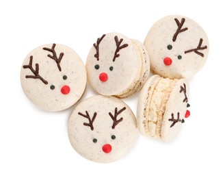 Tasty reindeer Christmas macarons on white background, top view