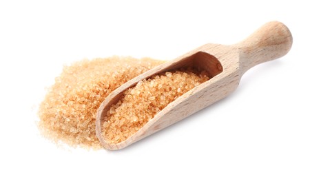 Wooden scoop and brown sugar on white background