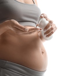 Pregnant woman with cosmetic product on white background, closeup