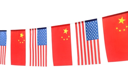 Garland with USA and China flags on white background. International relations