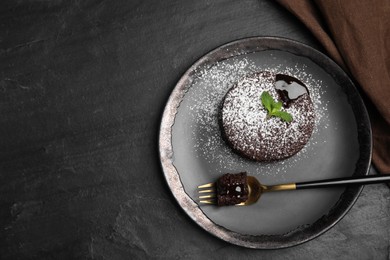 Delicious fresh fondant with hot chocolate and mint on black table, top view. Space for text