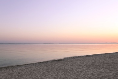 Sandy beach near sea at summer sunset