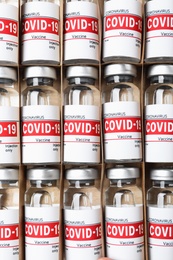 Glass vials with COVID-19 vaccine in package, top view