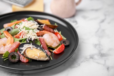 Photo of Plate of delicious salad with seafood on white marble table, closeup. Space for text
