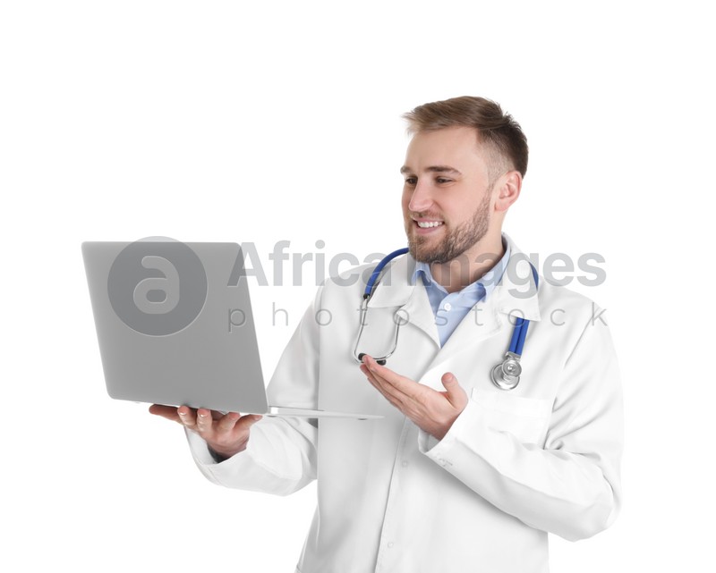 Photo of Male doctor using video chat on laptop against white background