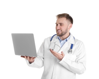 Male doctor using video chat on laptop against white background