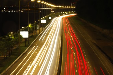 Road with light trails in city, motion blur effect. Night life