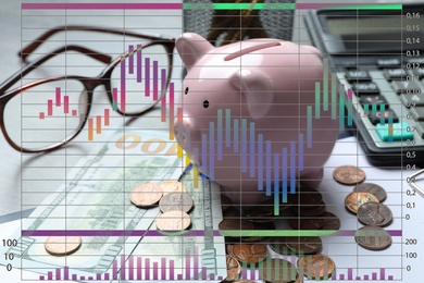 Finance trading concept. Piggy bank with coins on table and chart
