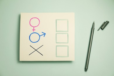 Gender equality. Pen near card with cross mark, male and female symbols on light grey background, flat lay