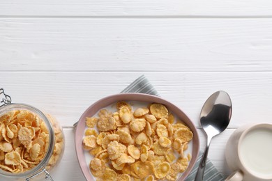 Tasty cornflakes with milk served on white wooden table, flat lay. Space for text