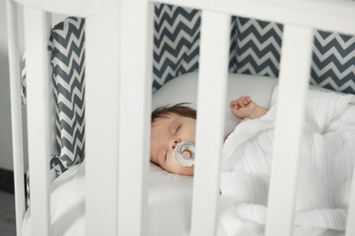 Photo of Cute little baby sleeping on cosy crib