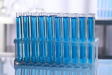 Test tubes with reagents on table in laboratory