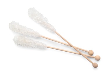 Wooden sticks with sugar crystals isolated on white, top view. Tasty rock candies