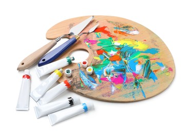 Palette with acrylic paints and spatulas on white background. Artist equipment