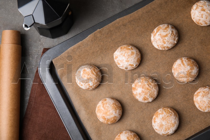 Photo of Tasty homemade gingerbread cookies on grey table, flat lay