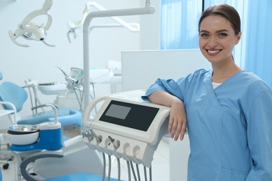 Portrait of professional dentist at workplace in clinic