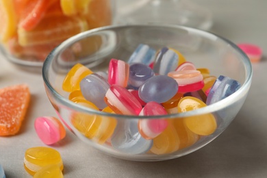 Tasty colorful sweets on light grey table, closeup