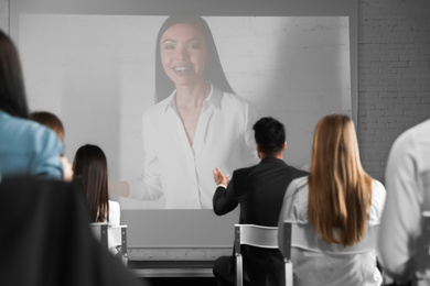 Video conference with female business trainer in office