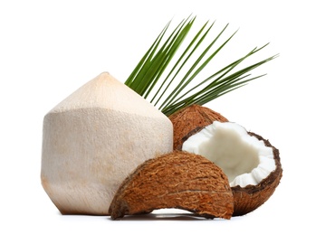 Fresh ripe coconuts with leaves on white background