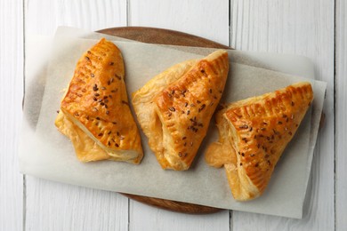 Photo of Fresh delicious puff pastry on white wooden table, top view