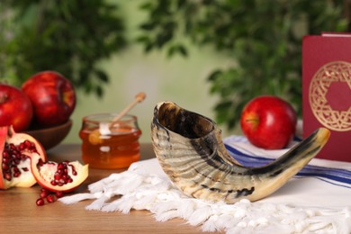 Composition with Rosh Hashanah holiday symbols on wooden table