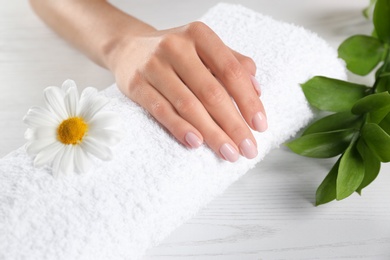 Beautiful female hand on towel, closeup. Spa treatment